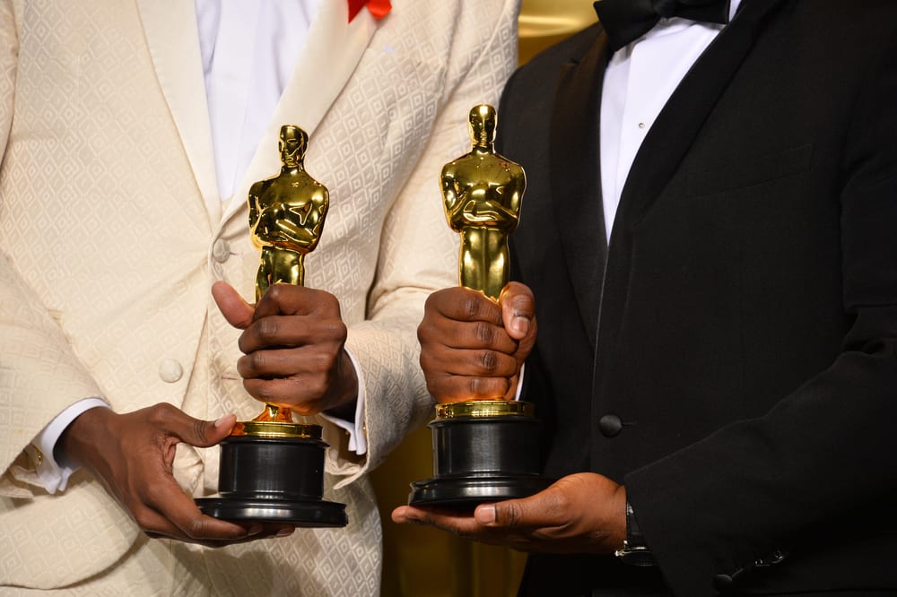 oscars winners holding trophies