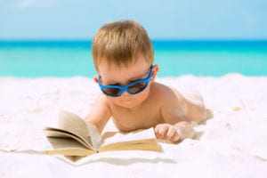 a small child beach reading