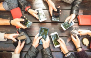 circle of hands holding smartphones