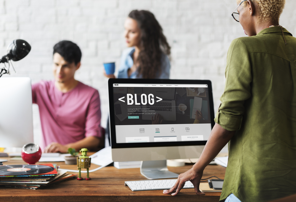 three coworkers writing a blog