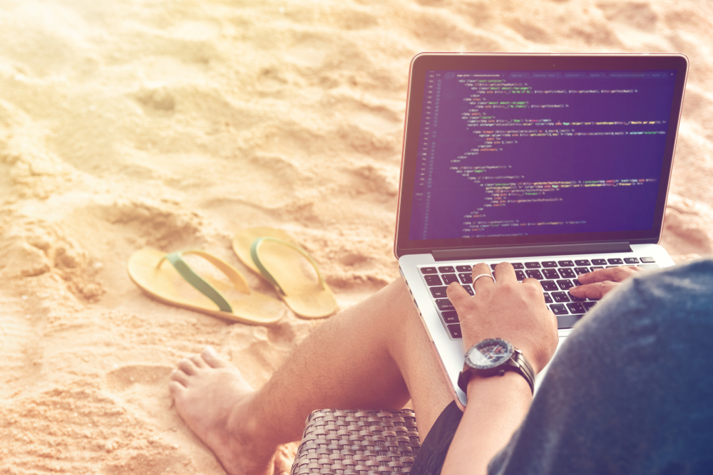 coder on the beach with laptop