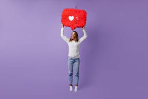 girl holding a single like symbol above her head