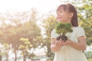 earth day, cute girl holding baby tree